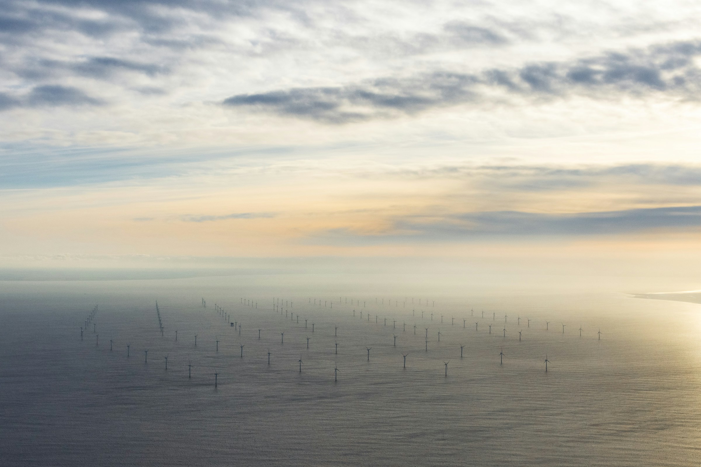 Offshore wind farm in a misty seascape
